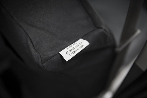 Close-up of a label on a black garment with visible text.