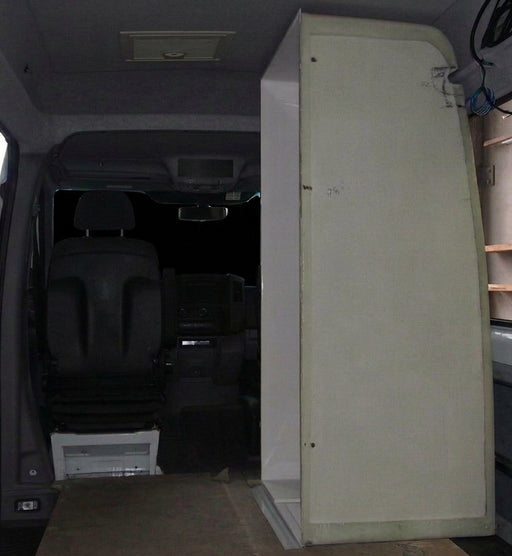 Shower cubicle fitted behind the driver's seat of a Mercedes Sprinter
