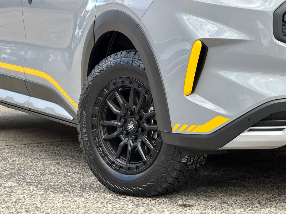 Close-up of a car tire with black rim and yellow accents on Ford Transit Custom vehicle.