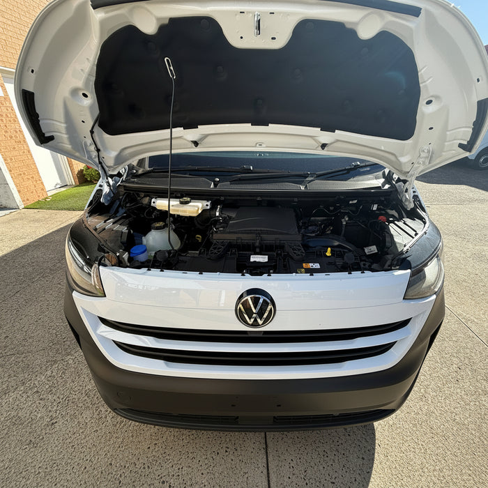 White T7 Volkswagen van with open hood on a driveway