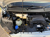 Car engine compartment with various components visible