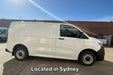 White t7 transporter van parked on a concrete surface with a clear blue sky.