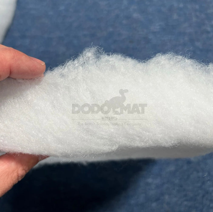 Person holding a roll of white foam with DodoMat branding.